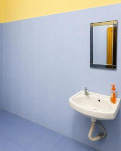 a bathroom with a sink and a mirror at Moonleaf Stay, Guwahati in Guwahati