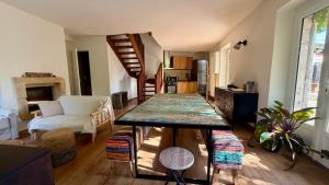 a living room with a table in the middle of a room at L'Autre Paradis-Piscines naturelles-Plages-Jardin enchanté-Sauna in Poligny +21 photos