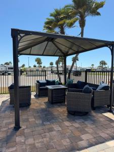a pavilion with couches and tables under a canopy at Tami Beach Resort Rental in Fort Myers Beach
