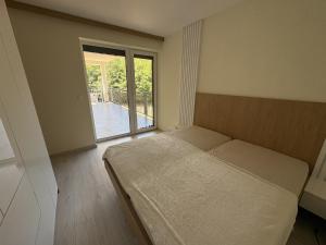 a bedroom with a bed and a large window at Belvedere Luxury Suite in Bojnice