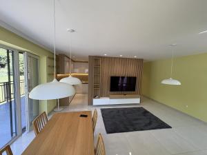 a living room with a table and a tv at Belvedere Luxury Suite in Bojnice