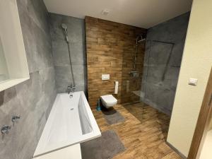a bathroom with a tub and a toilet and a shower at Belvedere Luxury Suite in Bojnice +4 photos