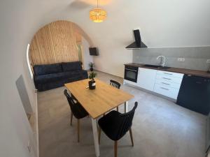 a kitchen and living room with a table and a couch at Il Castello 1800 in Trifilliánika