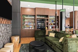 a living room with a green couch and a table at The Wills Hotel in Cumberland
