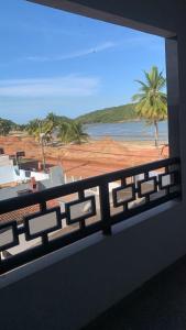 a view of a beach from a balcony at Piúma Palace Hotel in Piúma