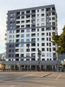 a large white building with a parking lot in front of it at Harbour Light Residence in Bjeliši