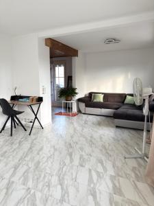 a living room with a couch and a table at Helle Wohnung nahe Bern in Worb +11 photos