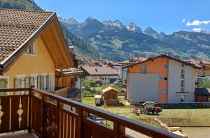 a view of a town with mountains in the background at My sweet home in the Dolomites - Appartamento LatteMiele in Predazzo