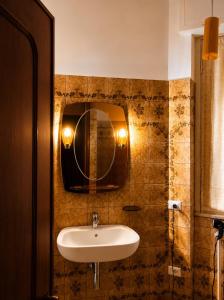 a bathroom with a sink and a mirror on the wall at Room between Milan and Como in Seregno +13 photos