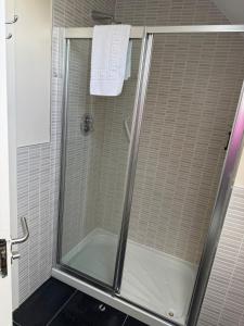 a shower with a glass door in a bathroom at Large four bedroom town centre house in Killarney +22 photos