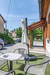 a table and chairs and an umbrella on a patio at House Majda in Zagreb