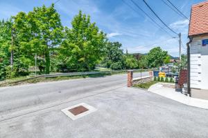 an empty street with a building and trees at House Majda in Zagreb