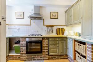 a kitchen with green cabinets and a stove top oven at 2 Bed in Newark oc-o36894 in Newark-on-Trent