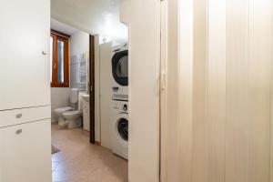 a white bathroom with a washer and dryer in it at My Tiny Home Venice in Marghera