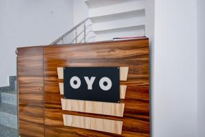 an ovo sign on a wall next to a staircase at HOTEL O SAV INN in Bhauli