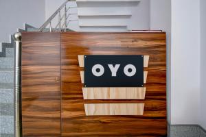 a wooden door with the oo sign on it at HOTEL O SAV INN in Bhauli