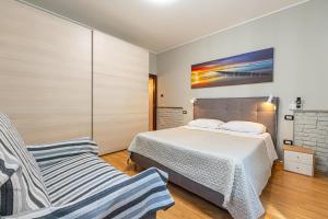 a bedroom with a bed and a chair in it at My Tiny Home Venice in Marghera