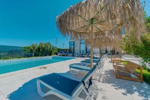 a group of chairs and an umbrella and a pool at InWaves in Vama Veche