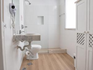 a bathroom with a sink and a toilet at Mango Tree Ipanema in Rio de Janeiro +28 photos