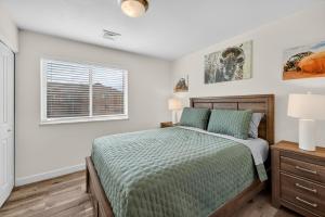 a bedroom with a bed and a window at Moab Redcliff Condos in Moab