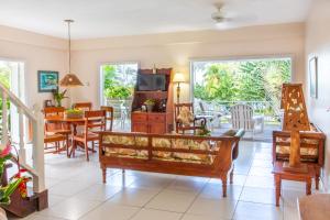 a living room filled with furniture and a dining room at Plantation Beach Villas in Black Rock