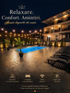 a resort with a swimming pool at night at GREY VILLAS in Călimăneşti