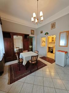 a kitchen and dining room with a table and chairs at Retró Kúria in Fonyód