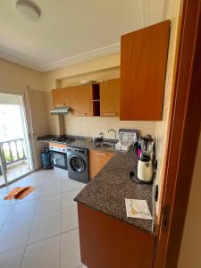 a kitchen with a sink and a stove top oven at Marina golf A in Asilah