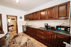 a kitchen with wooden cabinets and a black counter top at Vila Hubertus in Avrig