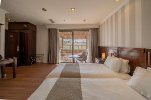 a hotel room with a large bed and a desk at Christmas Hotel - Jerusalem in Jerusalem +44 photos