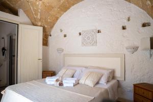 a bedroom with a white bed with two pillows at Ercole B&B in Ugento