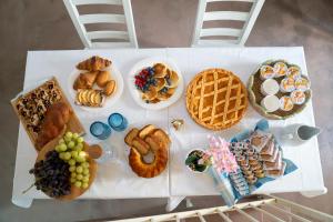 a table topped with lots of different types of breakfast foods at Ercole B&B in Ugento
