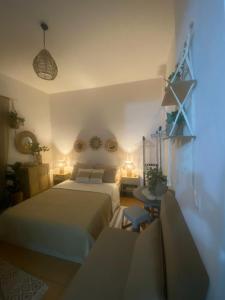 a bedroom with two beds and a table with lights at Studio DKMK in Malia