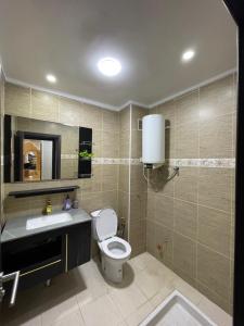 a bathroom with a toilet and a sink and a mirror at Appartement cozy in Oujda