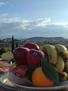 a bowl of fruit on a plate on a table at Chambre d'hôte in Midelt