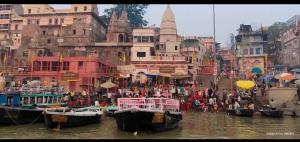 a group of boats in the water in a city at Alaknanda lodge in Varanasi +5 photos