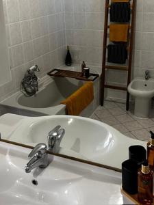 a bathroom with a sink and a bath tub at Casa Didavani 2-6 people in Belveglio +46 photos