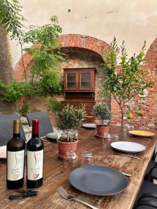 a wooden table with two bottles of wine on it at Casa Didavani 2-6 people in Belveglio