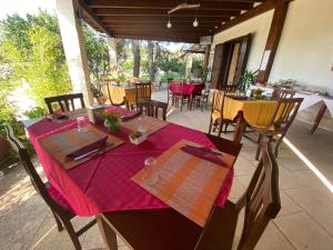 a table with a red table cloth on a patio at Agriturismo Monte degli Angeli in Serrano