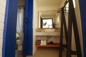 a bathroom with a sink and a toilet and a mirror at Café e Cabanas Lenha no Fogo in Urubici +72 photos