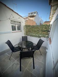 a patio with a table and chairs on a balcony at A vacation by the sea in Puerto de Sagunto