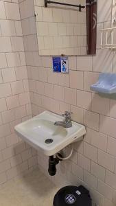 a bathroom with a white sink and a toilet at Hotel Bachue Ibagué in Ibagué +11 photos