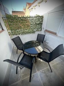 two chairs and a table and a table and chairs at A vacation by the sea in Puerto de Sagunto