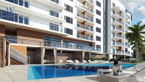 an exterior view of a building with a swimming pool at CW Hotel in Clearwater Beach