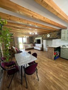 a kitchen and living room with a table and chairs at Casa CABAÑA in Riaño