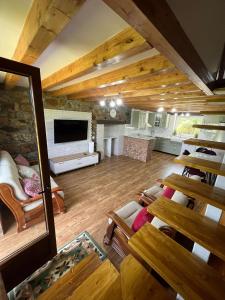 a large living room with wooden floors and wooden ceilings at Casa CABAÑA in Riaño