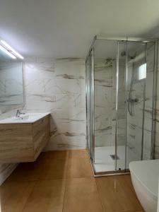 a bathroom with a shower and a sink at Casa CABAÑA in Riaño +5 photos