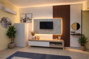 a living room with a television on a wall at Suite la Ficara in Bovalino Marina