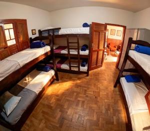 a room with four bunk beds in it at Nuh Hostel in Ouro Preto