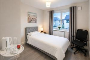 a bedroom with a bed and a desk and a chair at The Dene Homestay in Drogheda